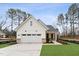 Charming, modern farmhouse style home with white siding, two-car garage, and well-manicured front lawn at 502 Gainer Dr # 2, Raleigh, NC 27610