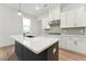 Modern kitchen island with a black base and white counter top in a well-lit space with white cabinets at 502 Gainer Dr # 2, Raleigh, NC 27610