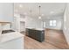 Open-concept kitchen with stainless steel appliances, a center island, and sleek, light-colored countertops at 502 Gainer Dr # 2, Raleigh, NC 27610
