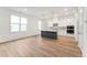 Bright kitchen with shaker cabinets, stainless appliances, a kitchen island and hardwood style flooring at 502 Gainer Dr # 2, Raleigh, NC 27610