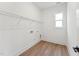 Functional laundry room with wire shelving, tile floors, and a window offering natural light at 502 Gainer Dr # 2, Raleigh, NC 27610