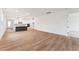Spacious open-concept living space showcasing hardwood floors, a kitchen with island, and neutral decor at 502 Gainer Dr # 2, Raleigh, NC 27610