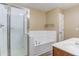 Elegant bathroom featuring a shower, soaking tub, and double sink vanity at 5110 Neuse Commons Ln # 109, Raleigh, NC 27616