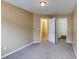 Bedroom featuring neutral carpet and walls, with a view of the hallway and closet at 5110 Neuse Commons Ln # 109, Raleigh, NC 27616