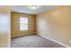 Bedroom featuring neutral carpet and cream walls, brightened by a window with blinds at 5110 Neuse Commons Ln # 109, Raleigh, NC 27616