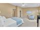 Spacious bedroom with a king-size bed, ceiling fan, and stylish accent chair at 5110 Neuse Commons Ln # 109, Raleigh, NC 27616
