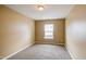 Cozy bedroom features neutral carpet, cream walls, and a sunlit window with blinds at 5110 Neuse Commons Ln # 109, Raleigh, NC 27616