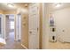 Neutral hallway showcases an updated water heater and access to carpeted rooms at 5110 Neuse Commons Ln # 109, Raleigh, NC 27616