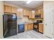 Functional kitchen with wooden cabinets, black appliances, and light countertops at 5110 Neuse Commons Ln # 109, Raleigh, NC 27616