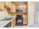 Efficient kitchen with light wooden cabinets and modern appliances at 5110 Neuse Commons Ln # 109, Raleigh, NC 27616