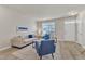 Inviting living room with a comfortable beige sofa, blue accent chairs, and ample natural light at 5110 Neuse Commons Ln # 109, Raleigh, NC 27616