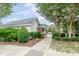 Community pool area featuring gated access, lush landscaping, and shade trees at 5110 Neuse Commons Ln # 109, Raleigh, NC 27616