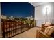 Relaxing balcony features cushioned chairs with a nighttime view of the city at 523 S West St # 404, Raleigh, NC 27601