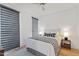 Bright bedroom featuring a ceiling fan, modern window shades, neutral decor and a queen-size bed at 523 S West St # 404, Raleigh, NC 27601