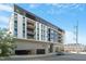 Modern condo building with sleek design and multiple balconies against a blue sky at 523 S West St # 404, Raleigh, NC 27601