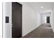 Hallway with a unit door and a view of the exit, with clean and modern design at 523 S West St # 404, Raleigh, NC 27601