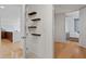 Hallway shows decorative shelves, entry door, kitchen, and the primary bedroom at 523 S West St # 404, Raleigh, NC 27601
