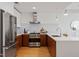 Modern kitchen features stainless steel appliances, white countertops, and wood cabinets at 523 S West St # 404, Raleigh, NC 27601