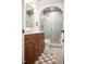 Bathroom featuring a double sink vanity with a tiled shower at 5312 Woodsdale Rd, Raleigh, NC 27606