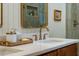 Bathroom featuring double sinks, designer fixtures and a tiled shower at 5312 Woodsdale Rd, Raleigh, NC 27606