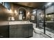 Modern bathroom with dark walls, chevron tile shower, and gold fixtures at 5312 Woodsdale Rd, Raleigh, NC 27606