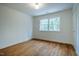 Bedroom with hardwood floors, white walls, and windows at 5312 Woodsdale Rd, Raleigh, NC 27606