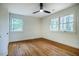 Bedroom with hardwood floors, white walls, and windows at 5312 Woodsdale Rd, Raleigh, NC 27606