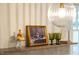 Close up of stylish countertop decor, including art, glassware, and a modern globe light fixture at 5312 Woodsdale Rd, Raleigh, NC 27606