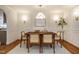 Charming dining room featuring decorative lighting, wooden floors, and wainscoting at 5312 Woodsdale Rd, Raleigh, NC 27606