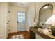 Entryway featuring light blue door, beautiful wood floors, console table, and ornate mirror at 5312 Woodsdale Rd, Raleigh, NC 27606