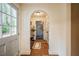 Elegant entryway with arched doorway, hardwood floors, and a view to another room at 5312 Woodsdale Rd, Raleigh, NC 27606