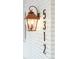 Unique house numbers on the white brick exterior with vintage lantern at 5312 Woodsdale Rd, Raleigh, NC 27606