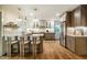 Open concept kitchen features a center island, modern appliances, and hardwood floors at 5312 Woodsdale Rd, Raleigh, NC 27606