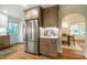 Modern kitchen with stainless steel refrigerator and view into the dining area at 5312 Woodsdale Rd, Raleigh, NC 27606