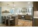 Spacious kitchen featuring hardwood floors, stainless steel appliances, and modern lighting at 5312 Woodsdale Rd, Raleigh, NC 27606