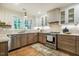 Modern kitchen with stainless steel appliances, natural light and stylish finishes at 5312 Woodsdale Rd, Raleigh, NC 27606