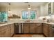 Updated kitchen featuring stainless steel appliances, granite countertops, and a window view of the trees at 5312 Woodsdale Rd, Raleigh, NC 27606