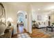 Elegant living room with hardwood floors, archway, classic white trim and neutral decor at 5312 Woodsdale Rd, Raleigh, NC 27606