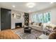 Inviting living room showcases a fireplace, hardwood floors and comfortable seating at 5312 Woodsdale Rd, Raleigh, NC 27606