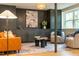 Inviting living room features custom built-ins, accent wall paneling, and comfortable seating around the coffee table at 5312 Woodsdale Rd, Raleigh, NC 27606