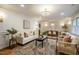 Bright and stylish living room with an open layout to the dining area, classic white trim, and hardwood floors at 5312 Woodsdale Rd, Raleigh, NC 27606
