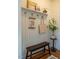 Cozy mudroom includes a wooden bench, shelf with decor, and coat hooks for organization at 5312 Woodsdale Rd, Raleigh, NC 27606