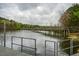 Scenic view of a lake with a long wooden bridge extending over the water, perfect for a peaceful walk at 5312 Woodsdale Rd, Raleigh, NC 27606