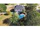 An aerial view of a well-maintained backyard and in-ground swimming pool with lush landscaping at 5408 Colonial Oaks Dr, Apex, NC 27539