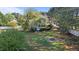 Large backyard with green grass, in-ground swimming pool, mature trees, and a fire pit at 5408 Colonial Oaks Dr, Apex, NC 27539