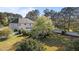 Large backyard with a swimming pool, green grass, a pergola, mature trees and a white fence at 5408 Colonial Oaks Dr, Apex, NC 27539
