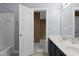 Bright bathroom featuring a double sink vanity, a tub with white tile surround, and neutral paint at 5408 Colonial Oaks Dr, Apex, NC 27539