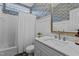 Well-lit bathroom with white vanity, floral wallpaper, and a shower-tub combo at 5408 Colonial Oaks Dr, Apex, NC 27539