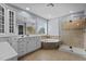 Modern bathroom featuring double sinks, a separate shower, a bathtub, and lots of cabinet space at 5408 Colonial Oaks Dr, Apex, NC 27539