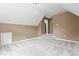 A cozy bedroom featuring a high ceiling and stairs leading to another room at 5408 Colonial Oaks Dr, Apex, NC 27539